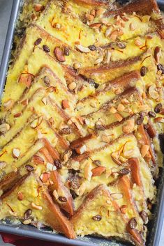 a casserole dish with carrots, almonds and other toppings on it