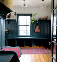 an image of a room that is very dark green with wood flooring and built in shelves