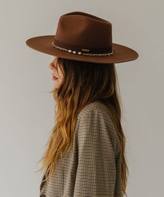 Think of the Raine as three hats in one. The removable paperclip brass chain features three pearls, + our first ever chain chinstrap can stay clipped into the hat or not, it’s totally up to you. Strip the Raine down to its basic form, the wide brim fedora, to showcase a hand-sewn grosgrain band with the gold Gigi Pip bar. This is a hat for a woman who loves options. Gigi Pip, Wide Brim Fedora, Halo Style, Wearing A Hat, Find Color, Felt Hat, Fedora Hat, Brass Chain, Wide Brimmed