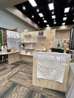 the interior of a retail store with white and beige items on display in front of them