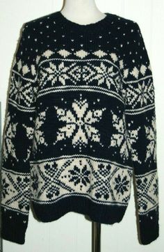 a black and white sweater with snowflakes on it