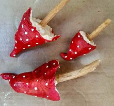 three red and white polka dot toothpicks sitting on top of each other