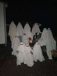 a group of people dressed up in ghost costumes