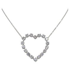 Circa 1990s Tiffany & Company Platinum Open Heart Necklace, the heart measuring 1 1/8 X 1 1/8 inches and is set with Fine White Round Brilliant cut Diamonds totaling 2 Carats. Suspended from a 16 inch Platinum link chain, both the Heart and chain are Tiffany signed. Comes in a Tiffany Presentation box. Rose Tiffany, Open Heart Necklace, Open Heart, 2 Carat, Round Brilliant Cut Diamond, Brilliant Cut Diamond, Tiffany & Co., Round Brilliant, Heart Necklace