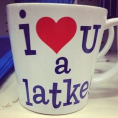 a coffee cup with the words i love you a latteke on it sitting on a desk