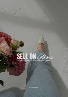 a person with their feet up on the wall next to a bouquet of flowers that reads sell on valentine's