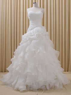 a white wedding dress on a mannequin