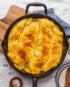 a cast iron skillet filled with food on top of a table