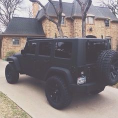 a black jeep parked in front of a house