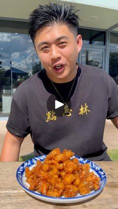 a man sitting at a table with a plate of food in front of his face