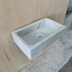 a white sink sitting next to a wall