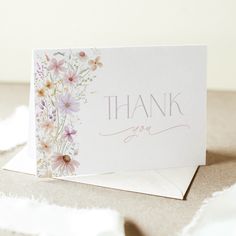 a thank you card with pink flowers on the front and purple daisies on the back