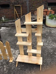 a wooden shelf sitting on top of a cement ground