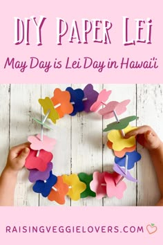 someone making a heart shaped paper lei with the words, may day is lei day in hawaii