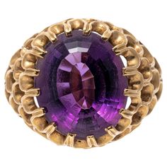 14k yellow gold ring. This wonderful ring has an oval faceted, medium to dark purple color amethyst, approximately 6.84 CTS and set into a wide, concentric open scalloped motif mounting. Marks: 14k Dimensions: 7/16" across the top x 9/16" long Weight: 5.7 gross dwt Amethyst Cocktail Ring, Amethyst Ring Vintage, Amethyst Set, Vintage Cocktail Ring, Green Amethyst Ring, Cocktail Jewelry, Ring Crafts, Royal Purple, North Korea