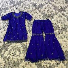 Handmade Girl's Sharara Set In Deep Blue With Embroidered Embellishments. Size: Small Teen Girl Or Extra Small, Short Woman Includes: Top (Extra Long Below Hips) Pants (Chiffon Style With Liner) Condition: Handmade, New. May Show Light Wear Or Discoloration From Storage. Gorgeous One Of A Kind Set. Blue Sharara With Dori Work For Party, Blue Embellished Party Set, Blue Embellished Sets For Festivals, Embellished Blue Sets For Festivals, Fitted Royal Blue Set For Festive Occasions, Fitted Royal Blue Festive Set, Festive Embellished Royal Blue Sets, Festive Fitted Royal Blue Set, Blue Embroidered Sharara For Party