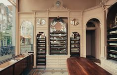 an empty room with lots of shelves on the wall and windows in front of it