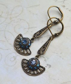 VINTAGE ELEMENTS Unique Jewellery, Handmade from Vintage Inspired, Original Designs. Exquisite Art Deco Antiqued Brass Filigree Earrings with Light Sappire and Montana Blue Swarovski Crystals. These Earrings have antiqued Brass leverback earwires and measure 4.4cm  from the top of the earwires. Light and Elegant. Retro Blue Earrings For Pierced Ears, Retro Blue Drop Earrings Jewelry, Retro Blue Drop Earrings, Blue Victorian Earrings For Wedding, Victorian Blue Earrings For Weddings, Ornate Blue Dangle Earrings, Blue Ornate Dangle Earrings, Vintage Round Earrings With Intricate Design, Art Deco Blue Drop Earrings