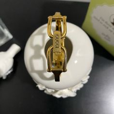 This Watch Is In Great Vintage Condition. There Are Hairline Scratches To The Gold-Tone Band, But No Major Scuffs Or Marks. Description Gucci Vintage Bangle Watch 0.5"W X 1"L Rectangle Watch Face 6.25" Band Circumference Gold-Tone Hardware Fold-Over Clasp Closure Narrow Bangle Style Watch 0.25" Approx. Band Width Logo Embossed At Clasp You Are Purchasing This Watch 'As Is'. Watch In Working Order At The Time Of Listing. May Require Service In The Future Dependent On Battery Life. 90s Gucci, Rectangle Watch, Pearl Watch, Bangle Watches, Gucci Vintage, Gucci Watch, Gucci Jewelry, Vintage Bangles, Style Watch