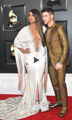 the singer and his wife are posing on the red carpet at an awards event together