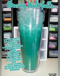 a tall glass filled with blue liquid sitting on top of a counter