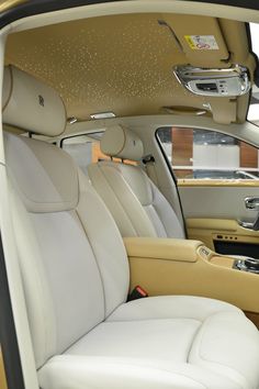 the interior of a car with white leather seats