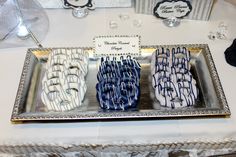 three decorated donuts sitting on top of a silver tray next to other items and decorations