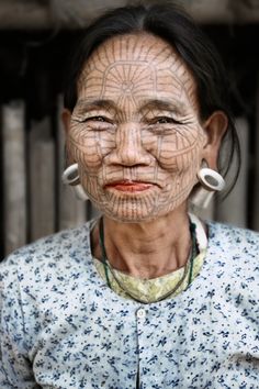 an old woman with tattoos on her face