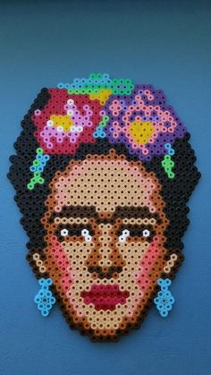 a woman with flowers on her head made out of perler beads