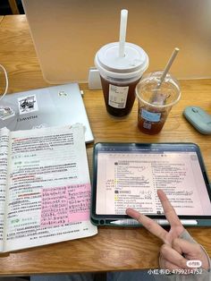 a person sitting at a table with an ipad and coffee in front of them, pointing to the screen