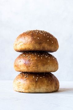 three sesame seed bagels stacked on top of each other