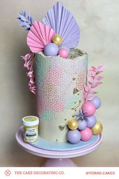 a cake decorated with pastel colors and decorations