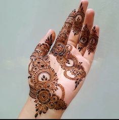 the hand is decorated with henna designs on it