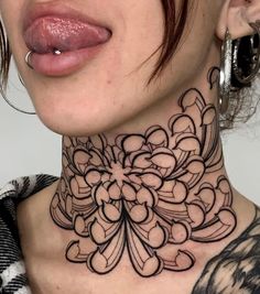 a close up of a woman's neck with an intricate design on her neck