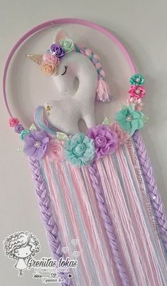 the unicorn is hanging on the wall with flowers in it's mane and hair