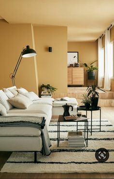 a living room with yellow walls and white furniture