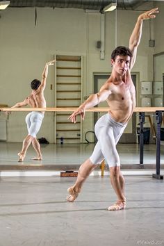 two men in white shorts are practicing ballet