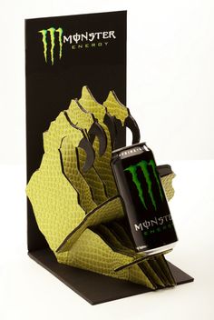 a monster energy drink in front of a box