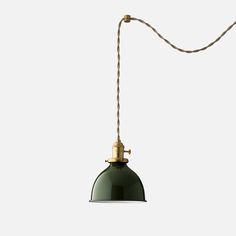 a green pendant light hanging from a rope