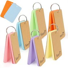 six different colored paper hangers with metal rings