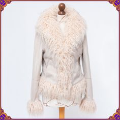 Show everyone your rock 'n' roll best in this warm and stylish vegan coat. This 1970s style  beauty is made from ultra soft fake suede & the fluffiest genuine vegan faux fur trim. It has two front pockets and hidden hook closures. Size M ⫸ ❀ 100% VEGAN ❀ ⫸ AMAZING timeless design ⫸ Beautiful pre-loved vintage condition! Without any stains or odors . Please see the pictures ♡ Don't      hesitate to contact me if you would like to see more photos. ⫸ Very light-weight, soft and cozy ⫸ hook & eye cl Winter Sheepskin Outerwear With Feather Trim, Fitted Fringe Outerwear For Winter, Bohemian Faux Fur Coat For Winter, Bohemian Fitted Fur Coat For Winter, Fitted Bohemian Fur Coat For Winter, Afghan Coat, Mongolian Fur, 1970s Style, Penny Lane