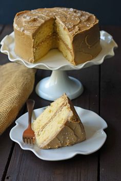 two pieces of cake on white plates with one slice missing from the rest of the cake