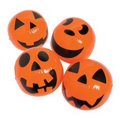 four orange halloween pumpkin balloons with black faces on each one, all in the shape of jack - o'- lanterns