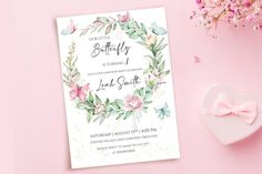 a pink and white floral birthday party card with a heart shaped box next to it