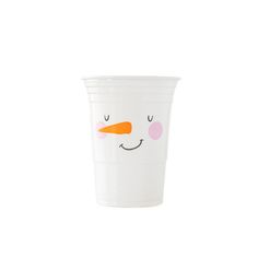 a white cup with a face drawn on the side and an orange carrot sticking out of it