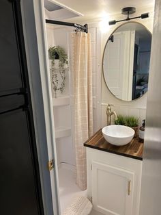 a bathroom with a sink, mirror and bathtub in the shower stall is shown