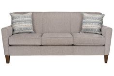 a gray couch with two pillows on it