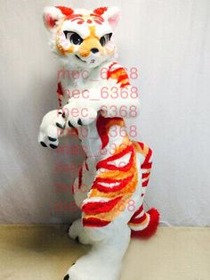 a white and orange stuffed animal standing on its hind legs