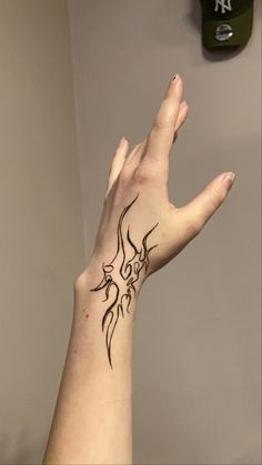 a woman's hand with a tattoo on it and a clock above her head