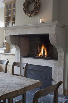 a fire place in the middle of a dining room